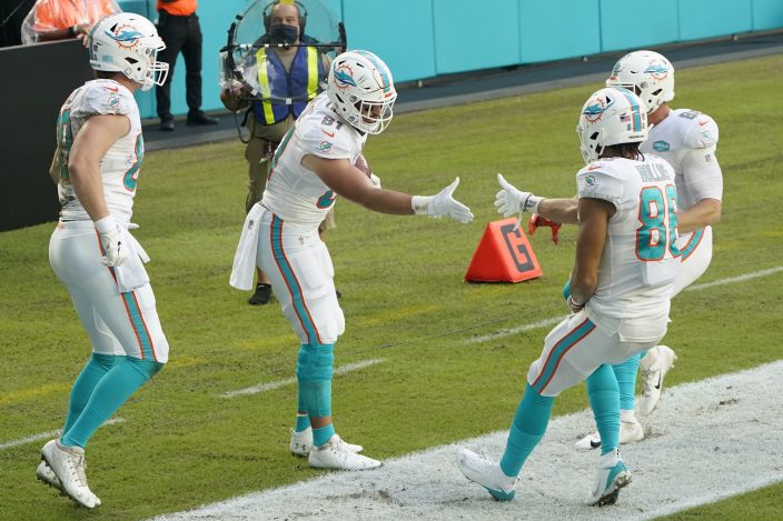 Miami Dolphins wide receiver Mack Hollins (86) runs for a