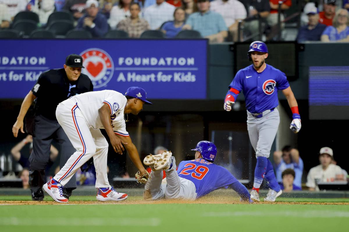 World champion Rangers overcome disputed tip and beat Cubs 4-3 on Heim ...